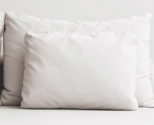 Almohada blanca para dormir de lado en un cabecero de cama